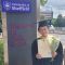 Mengzi Li in cap and gown holding her graduation certificate